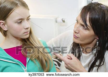 Woman scolding her daughter at home View Large Photo Image Stock Image - Woman scolding her daughter at home. Fotosearch
