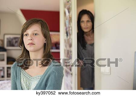 Woman watching her daughter behind the door in the bedroom View Large Photo Image Stock Image - Woman watching her daughter behind the door in the bedroom. Fotosearch