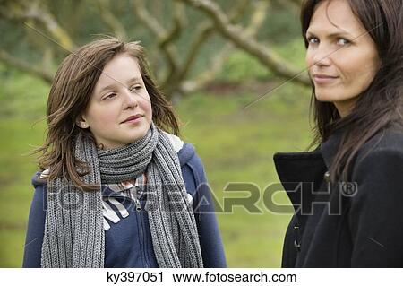 Woman with her daughter in an orchard View Large Photo Image Stock Image - Woman with her daughter in an orchard. Fotosearch