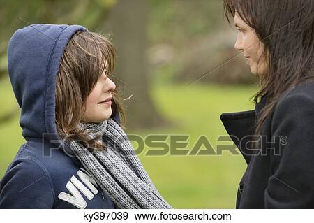 Woman with her daughter in an orchard View Large Photo Image Stock Photo - Woman with her daughter in an orchard. Fotosearch