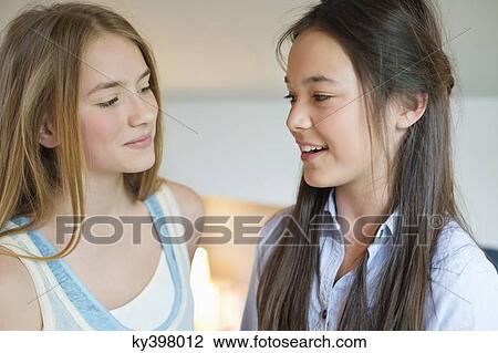 Close-up of two girls smiling View Large Photo Image Stock Image - Close-up of two girls smiling. Fotosearch