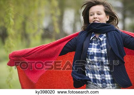 Girl holding a blanket with her arm outstretched View Large Photo Image Stock Image - Girl holding a blanket with her arm outstretched. Fotosearch