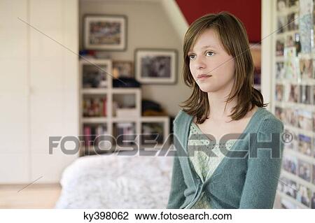 Girl sitting on the bed and thinking View Large Photo Image Stock Image - Girl sitting on the bed and thinking. Fotosearch