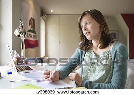 Stock Photo - Girl studying at home. Fotosearch