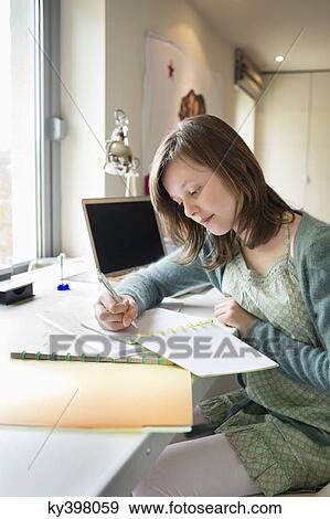 Girl studying at home View Large Photo Image Stock Photo - Girl studying at home. Fotosearch