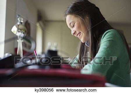 Girl studying at home View Large Photo Image Stock Photograph - Girl studying at home. Fotosearch