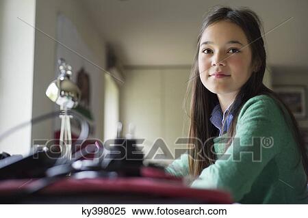 Stock Photography - Girl studying at home. Fotosearch