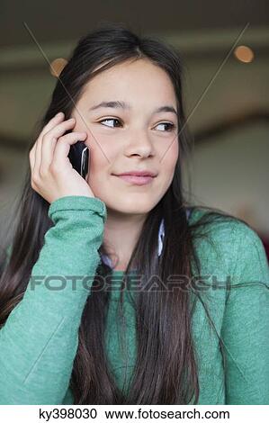 Stock Image - Girl talking on a mobile phone. Fotosearch