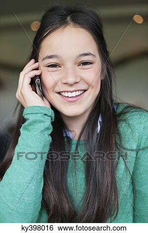 Girl talking on a mobile phone View Large Photo Image Stock Photograph - Girl talking on a mobile phone. Fotosearch