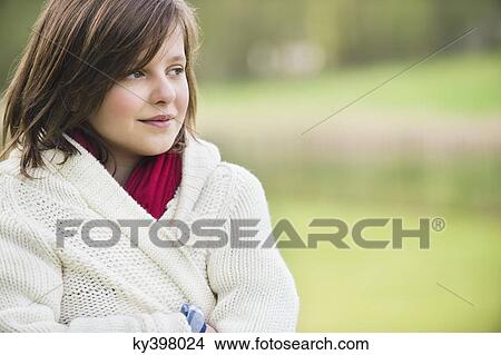 Girl thinking in a park View Large Photo Image Picture - Girl thinking in a park. Fotosearch