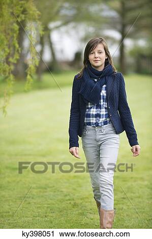 Girl walking in a field View Large Photo Image Stock Image - Girl walking in a field. Fotosearch