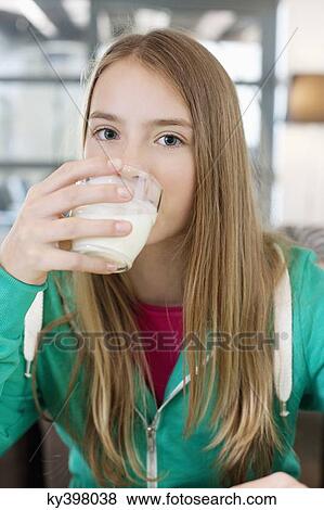 Portrait of a girl drinking milk View Large Photo Image Stock Photo - Portrait of a girl drinking milk. Fotosearch