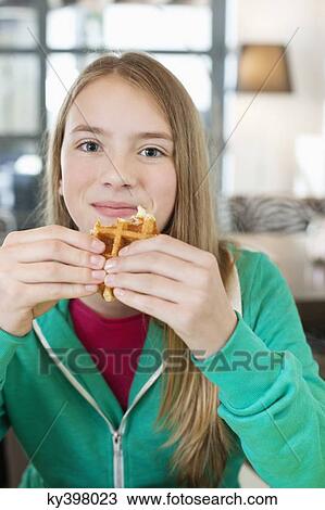 Portrait of a girl eating waffle View Large Photo Image Stock Image - Portrait of a girl eating waffle. Fotosearch