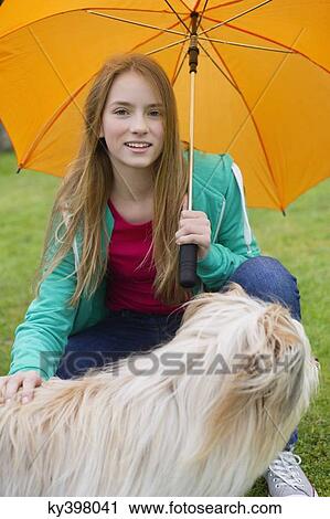 Portrait of a girl pampering her dog View Large Photo Image Stock Image - Portrait of a girl pampering her dog. Fotosearch