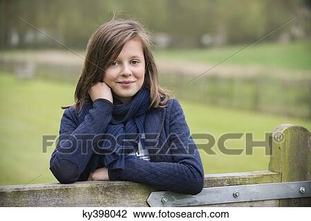 Portrait of a girl smiling in a farm View Large Photo Image Stock Image - Portrait of a girl smiling in a farm. Fotosearch