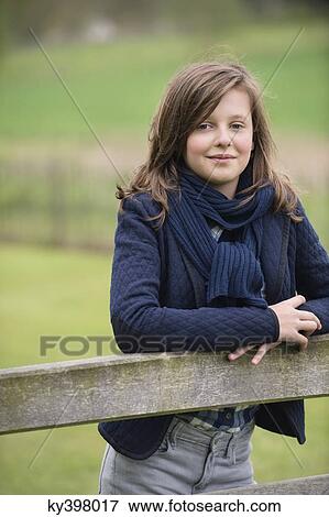 Stock Photo - Portrait of a girl smiling in a farm. Fotosearch