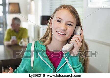 Portrait of a girl talking on a phone and smiling View Large Photo Image Stock Photography - Portrait of a girl talking on a phone and smiling. Fotosearch