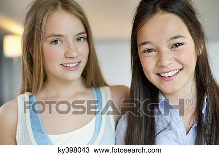Portrait of two girls smiling View Large Photo Image Stock Image - Portrait of two girls smiling. Fotosearch
