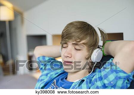 Teenage boy listening to music View Large Photo Image Stock Photo - Teenage boy listening to music. Fotosearch