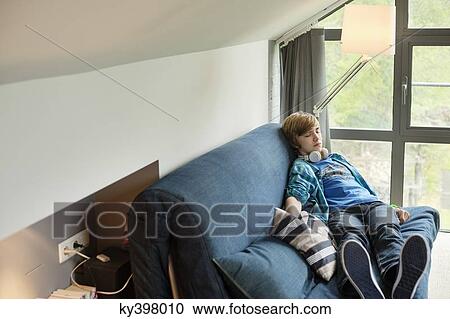 Teenage boy sleeping on a couch at home View Large Photo Image Stock Image - Teenage boy sleeping on a couch at home. Fotosearch