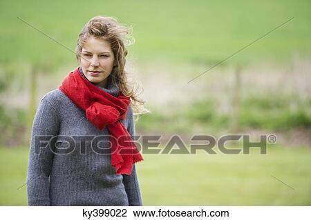 Beautiful woman standing in a field View Large Photo Image Stock Image - Beautiful woman standing in a field. Fotosearch