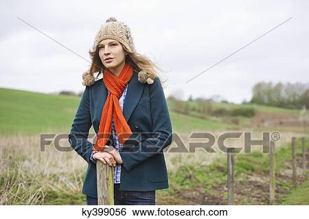 Beautiful woman standing in a field View Large Photo Image Stock Photograph - Beautiful woman standing in a field. Fotosearch