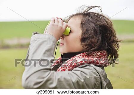 Boy looking through binoculars View Large Photo Image Stock Image - Boy looking through binoculars. Fotosearch