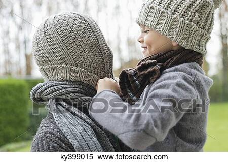Stock Photography - Boy playing with his father's cap. Fotosearch