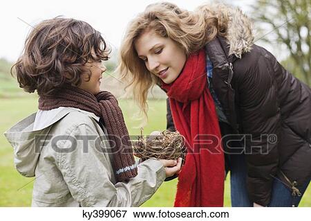 Boy showing eggs in nest to his mother View Large Photo Image Stock Photo - Boy showing eggs in nest to his mother. Fotosearch