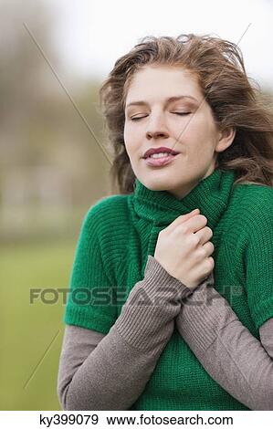 Stock Photo - Close-up of a woman shivering. Fotosearch