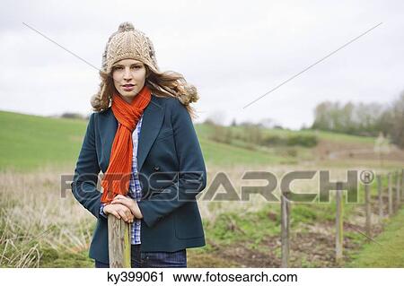 Stock Image - Portrait of a woman standing in a field. Fotosearch