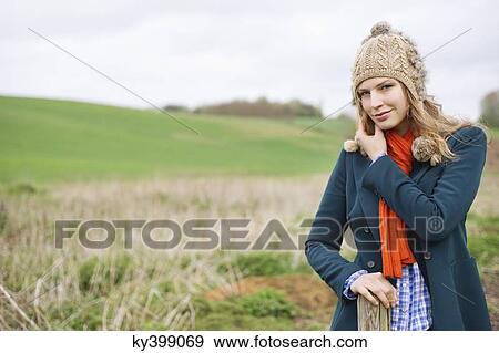 Portrait of a woman standing in a field View Large Photo Image Stock Photo - Portrait of a woman standing in a field. Fotosearch