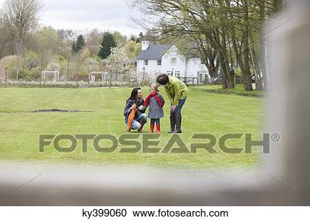 Two women convincing a displeased girl in a park View Large Photo Image Stock Image - Two women convincing a displeased girl in a park. Fotosearch