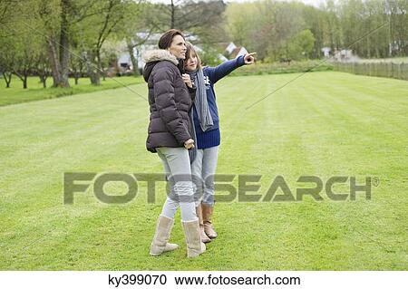 Woman with her daughter in a park View Large Photo Image Stock Image - Woman with her daughter in a park. Fotosearch