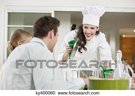 Happy female chef serving food View Large Photo Image Stock Image - Happy female chef serving food. Fotosearch