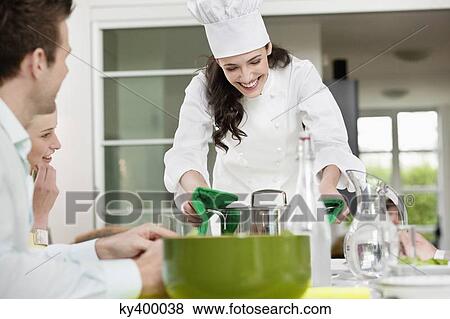 Happy female chef serving food View Large Photo Image Stock Photo - Happy female chef serving food. Fotosearch