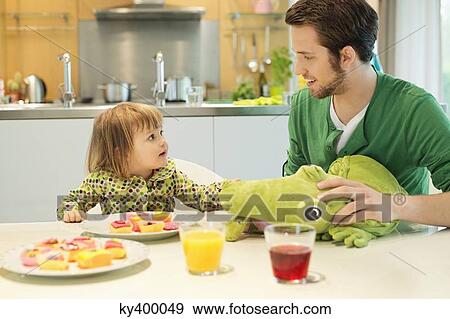 Man and daughter at breakfast table View Large Photo Image Stock Photo - Man and daughter at breakfast table. Fotosearch
