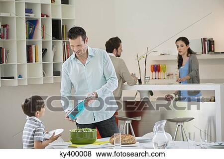 Man and son setting table for lunch View Large Photo Image Stock Photo - Man and son setting table for lunch. Fotosearch