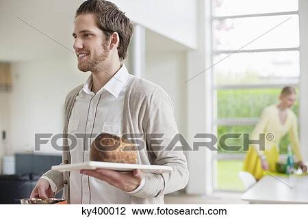 Stock Image - Man carrying bread on a tray. Fotosearch