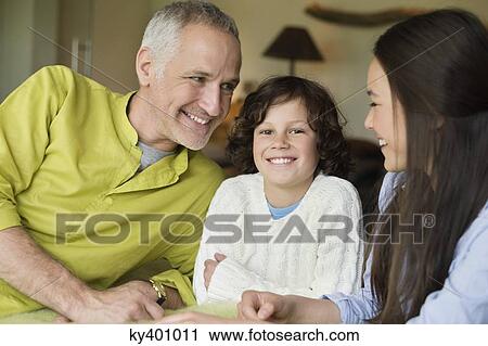 Stock Image - Close-up of a man with his children smiling. Fotosearch