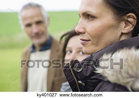 Stock Photo - Close-up of a woman with her family. Fotosearch