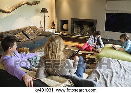 Stock Image - Family in a living room. Fotosearch