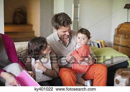 Stock Image - Family sitting together. Fotosearch