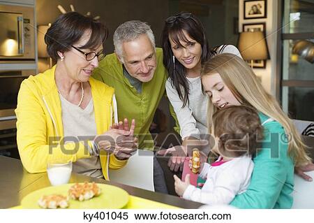 Stock Photography - Happy family at the breakfast table. Fotosearch