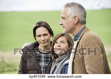 Happy family in a field View Large Photo Image Stock Photo - Happy family in a field. Fotosearch