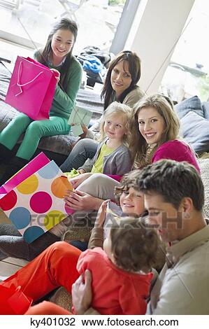 Happy family sitting together at home View Large Photo Image Stock Image - Happy family sitting together at home. Fotosearch