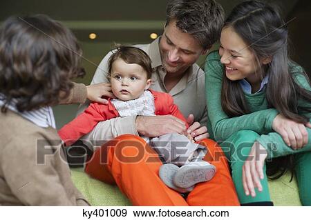 Stock Photo - Happy man with their children at home. Fotosearch