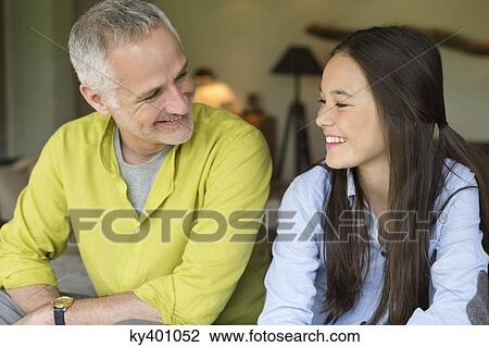 Man and his daughter smiling at home View Large Photo Image Stock Image - Man and his daughter smiling at home. Fotosearch
