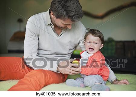 Man consoling his crying daughter View Large Photo Image Stock Photography - Man consoling his crying daughter. Fotosearch