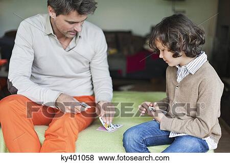 Man playing cards with his son View Large Photo Image Stock Photo - Man playing cards with his son. Fotosearch